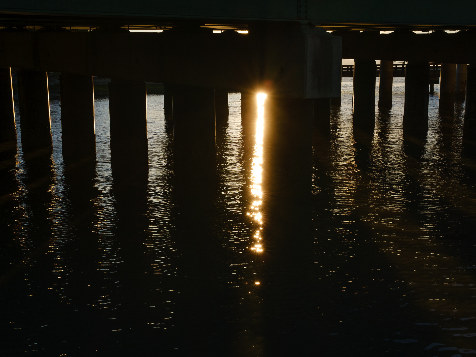 Sunset through bridge pillars