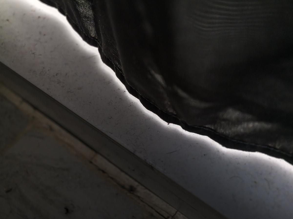 Gap between curtain and floor filled with bright light