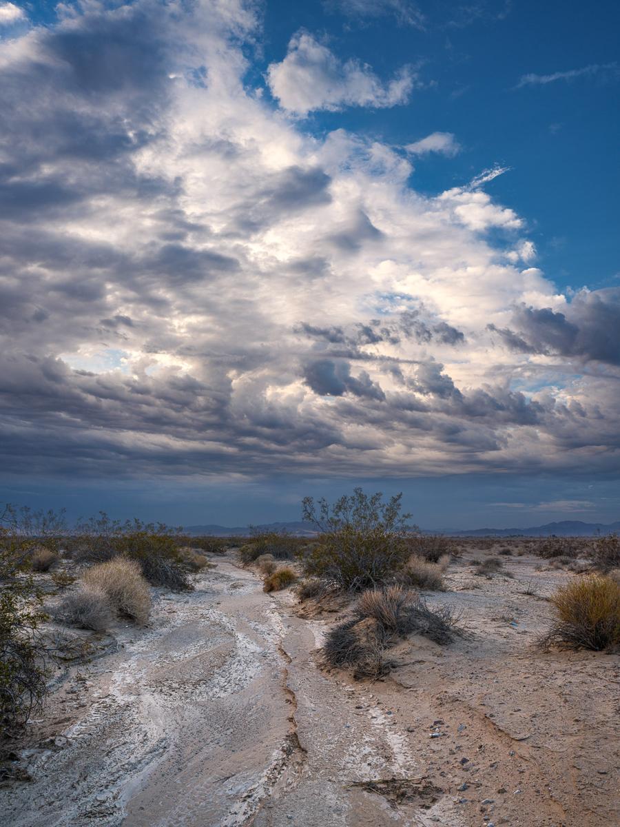 Cloud complex over dry desert wash.