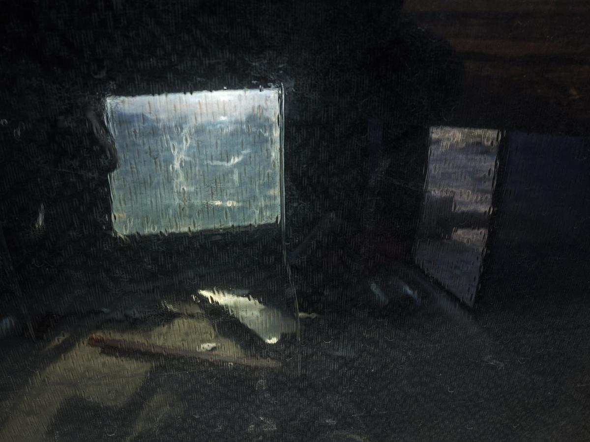 Debris lit from behind seen indistinctly through rippled glass.